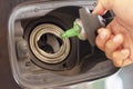 Close up Man hand open the gas tank and holds the gas tank cap Royalty Free Stock Photo