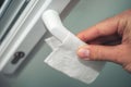 Close-up of man hand over a napkin on a door handle. Bacteria or virus protection concept Royalty Free Stock Photo