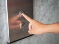 Close up man hand press a up button of elevator inside the build