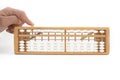 Close up a man hand is pressing abacus compilation button over white background. Royalty Free Stock Photo