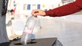 Man hand putting bottle of a plastic reuse for recycling concept environmental protection world recycle in park Royalty Free Stock Photo