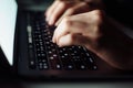 Close up man hand typing keyboard on laptop in darkness operating room, cyber security concept. Hacker using laptop Royalty Free Stock Photo