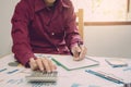 Close up man hand using calculator Calculating bonusOr other compensation to employees to increase productivity. Royalty Free Stock Photo