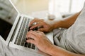 Close up man hand using laptop for work at home. Student hand doing his homework with laptop Royalty Free Stock Photo