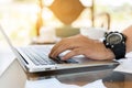 Close up man hand using laptop for work. Man hands typing on laptop keyboard Royalty Free Stock Photo