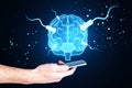 Close up of man hand using tablet with glowing connected brain hologram on blurry background. AI, mind and neurology concept