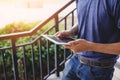 Close up of man hand using tablet while walking at outdoors. Technology and Lifestyles concept. Working people and Gadget theme. Royalty Free Stock Photo