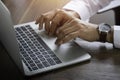 Close-up of man hand using and typing keyboard of laptop computer on office desk. Royalty Free Stock Photo