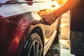 Close up of man hand washing car with water at car wash, People hand close up cleaning car with a sponge at the car wash, AI Royalty Free Stock Photo