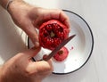 Top view of man hands cutting pomegranate with a knife Royalty Free Stock Photo