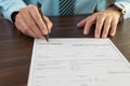 Close up man hands is filling out a job application form. Unemployed concept Royalty Free Stock Photo