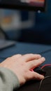 Close-up of man hands gamer playing video game using RGB keyboard