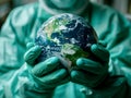 Close-up of man hands in green rubber gloves holding model of earth, globe, world health day Royalty Free Stock Photo