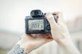 Close up of man hands holding camera and making photos of modern building. Royalty Free Stock Photo