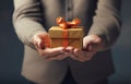 Close up of man hands holding christmas gift box over dark background Royalty Free Stock Photo