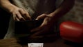Close up of man hands holding an open leather wallet with a few coins inside over a old wooden table with paper money Royalty Free Stock Photo