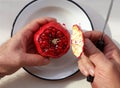Top view of man hands holding a partially peeled pomegranate and a knife Royalty Free Stock Photo