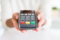 Close up of man hands holding point of sale terminal, dataphone for shopping paying using credit card