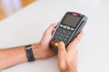 Close up of man hands holding point of sale terminal, dataphone for shopping paying using credit card