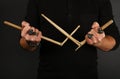 Man hands with broken drumsticks over black Royalty Free Stock Photo