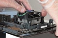 Close up of man hands installing CPU cooler fan on new, modern Royalty Free Stock Photo