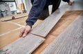 Male worker installing laminate floor in apartment. Royalty Free Stock Photo