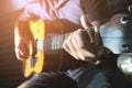 Close-up Man hands playing acoustic guitar with light flare Royalty Free Stock Photo