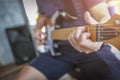 Close-up Man hands playing acoustic guitar with light flare Royalty Free Stock Photo