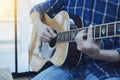 close up of a man hands playing guitar in a home with window light, praise and worsdhip concept Royalty Free Stock Photo