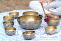 Close-up of man hands playing on a singing tibetian bowl with sticks. Sound healing music instruments for meditation Royalty Free Stock Photo