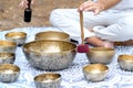 Close-up of man hands playing on a singing tibetian bowl with sticks. Sound healing music instruments for meditation Royalty Free Stock Photo