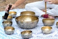 Close-up of man hands playing on a singing tibetian bowl with sticks. Sound healing music instruments for meditation Royalty Free Stock Photo