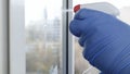 Close Up Man Hands with Protection Gloves Cleaning a Window Using Sprayed Liquid Disinfecting Against Viruses Royalty Free Stock Photo