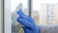 Close Up Man Hands with Protection Gloves Cleaning a Window Using Sprayed Liquid Disinfecting Against Viruses Royalty Free Stock Photo