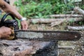 Man hands use a rasp to sharpen the blade chainsaw