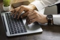 Close-up of man hands using keyboard of laptop computer on office desk. Royalty Free Stock Photo