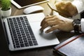 Close-up of man hands using keyboard of laptop computer on office desk. Royalty Free Stock Photo