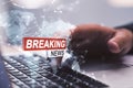 Close up of man hands using laptop with creative polygonal hi-tech breaking news hologram on blurry background. Television, online