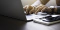 Close-up of man hands using and typing keyboard of laptop computer on office desk. Royalty Free Stock Photo