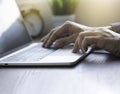 Close-up of man hands using and typing keyboard of laptop computer on office desk. Royalty Free Stock Photo