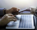 Close-up of man hands using and typing keyboard of laptop computer on office desk. Royalty Free Stock Photo