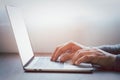 Close-up of man hands using and typing keyboard of laptop computer on office desk. Royalty Free Stock Photo