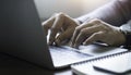 Close-up of man hands using and typing keyboard of laptop computer on office desk. Royalty Free Stock Photo