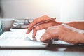 Close-up of man hands using and typing keyboard of laptop computer on office desk. Royalty Free Stock Photo