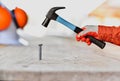 Close up of man hitting nail by hammer for construction Royalty Free Stock Photo