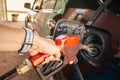 Close up of man hold an old petrol pump filling up fuel at gas station