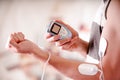 Close-up of a man holding an electrode machine in his hand and with electrostimulator electrodes in the arm of a fitness Royalty Free Stock Photo