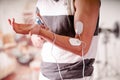 Close-up of a man holding an electrode machine in his hand and with electrostimulator electrodes in the arm of a fitness Royalty Free Stock Photo