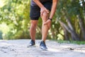 Close up of man holding knee in pain, sports injury inflammation trail run Royalty Free Stock Photo