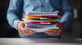 Close-up of a man holding a large stack of documents. AI generated